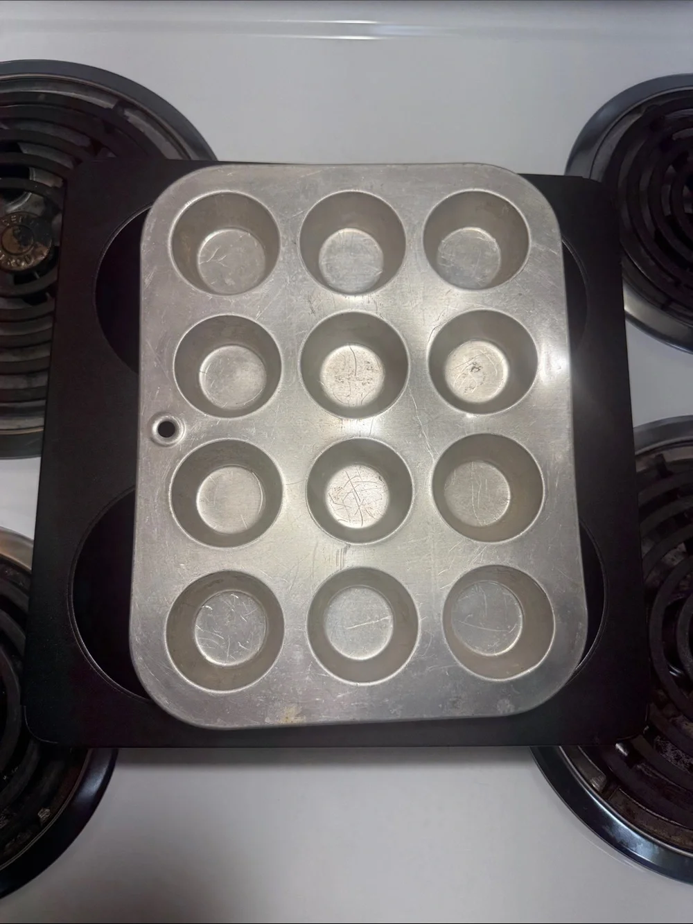 Two muffin pans, the large one is non-stick and NWOT. Small one is in GUC.